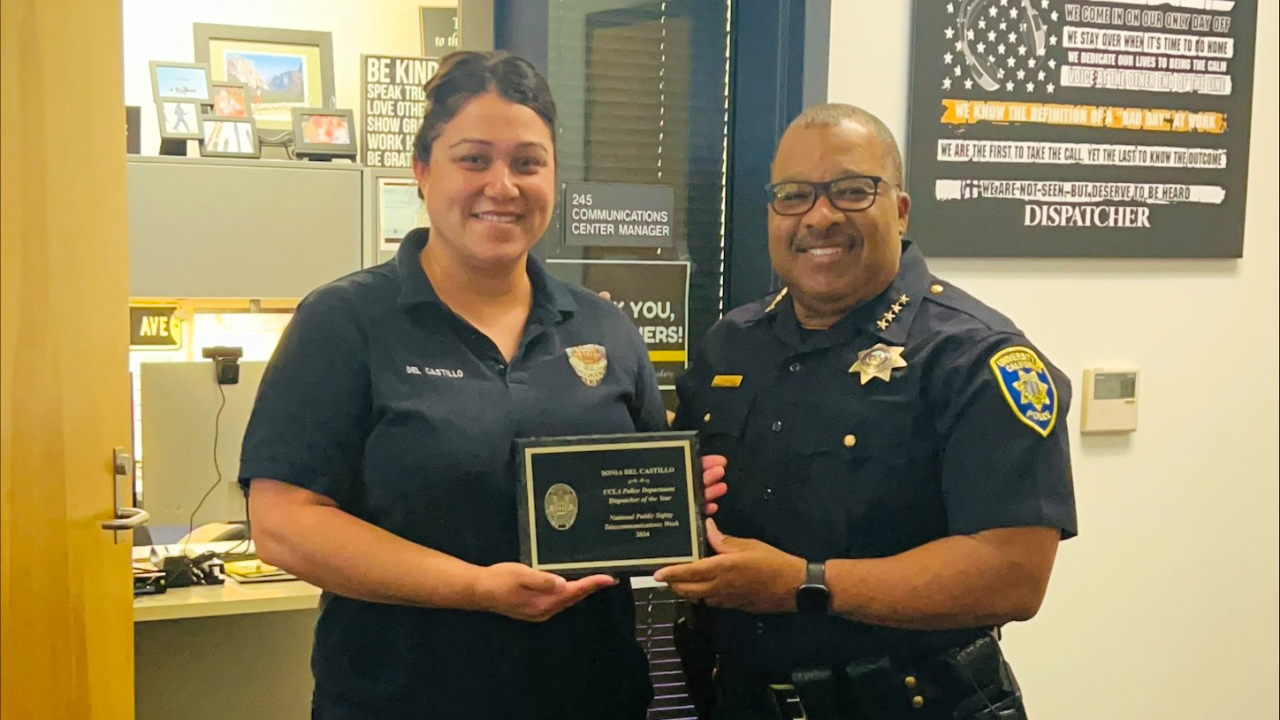 Sonia Del Castillo and Chief John Thomas holding Dispatcher of the Year award